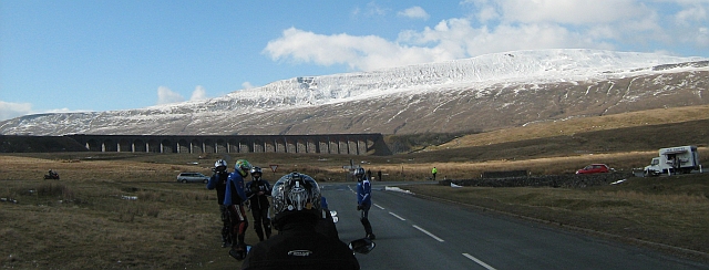 long many arched bridge with bikers in the foreground