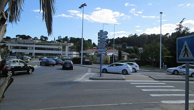 plain ordinary roundabout at la colle sur loup with traffic and buildings and faded crossings