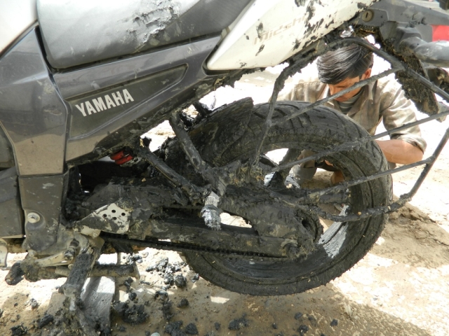 motorcycle covered in thick salt mud