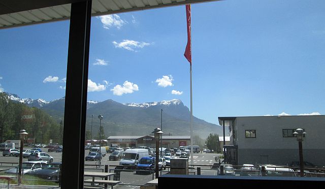 looking through the window in mcdonalds embrun to the snow capped mountains of the alps