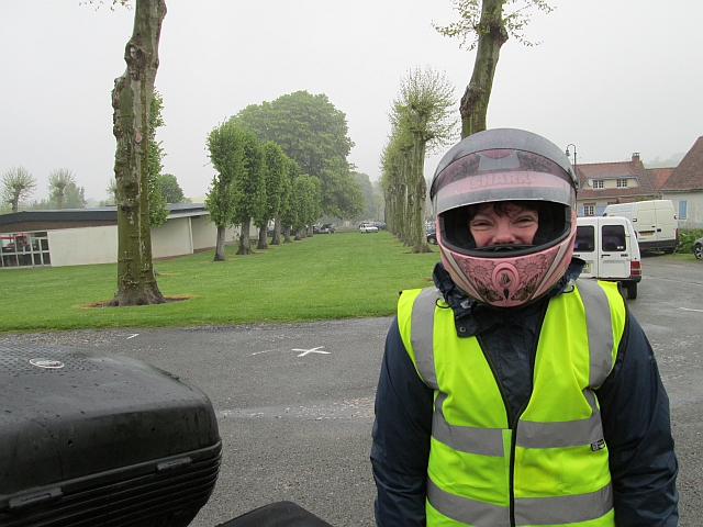th gf wearing her helmet and smiling despite the heavy rain