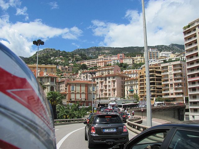 tall tower blocks, apartments and buildings all squeezed into the hillside and traffic in monaco