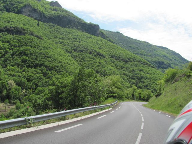 A smooth twisting road through trees and valleys