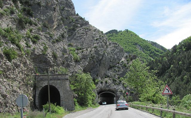 two road tunnels running through a rocky outcrop on the awesome road out of the alps towards nice