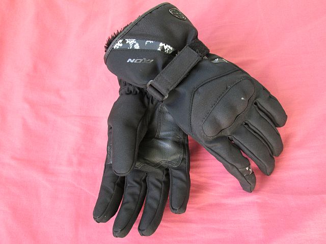 the gloves in question laid out on a pink cloth