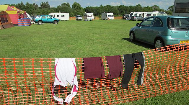 clothes drying on a plastic temporary fence at the campsite in lincolnshire