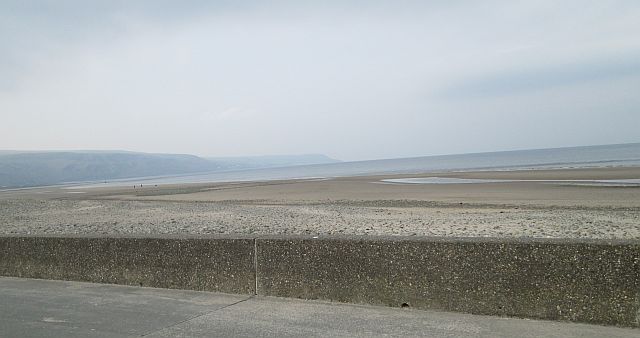 a broad wide beach, deserted and peaceful under the misty skies at barmouth