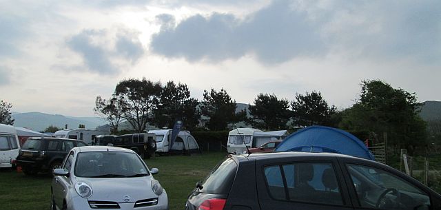 grey clouds roll in over the campers at pall mall campsite, tywyn