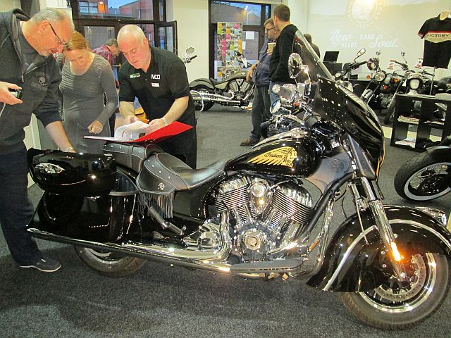 indian chieftain in balc at the showroom with potential customers