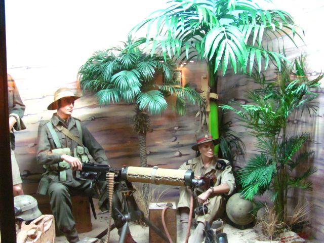 a machine gun manned by dummies dressed in desert fatigues