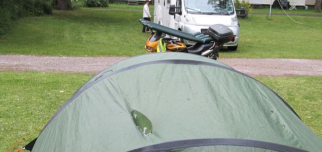 puddles on the top of the tent and the airbed drying on the bike
