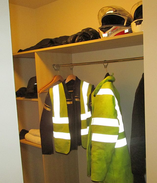 our helmets, jackets and waterproofs stored nicely on shelves in the hotel room
