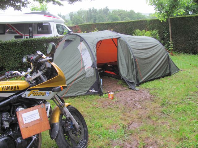 the tent and the bike with a line of mud to the tent entrance