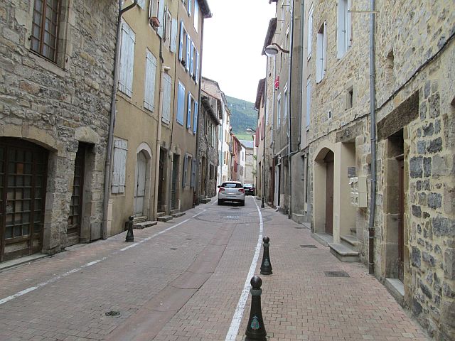 narrow street and tall french buildings in millau
