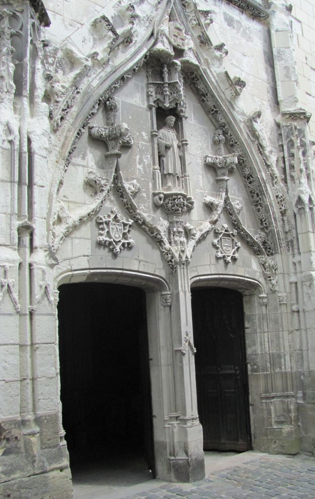incredibly ornate stone masonry around an open door to a church