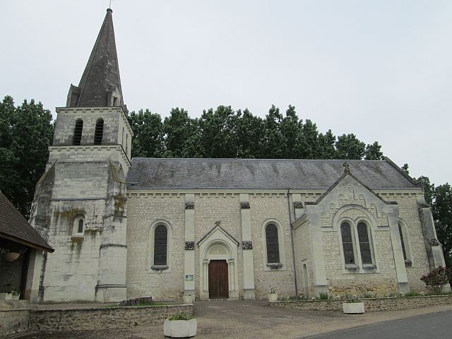 a french church with pointed spire and steep slate roof