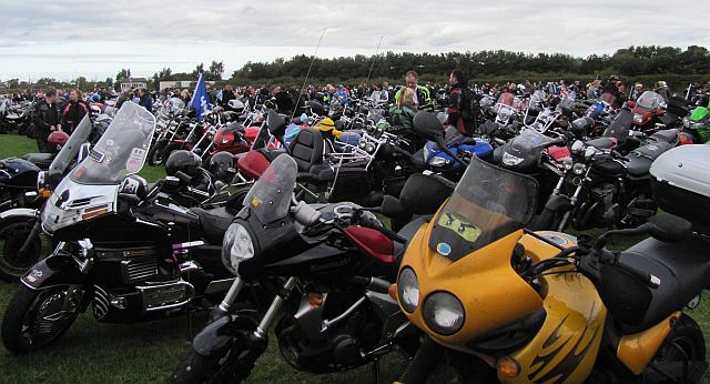 a field filled with motorcycles of all makes, models and styles