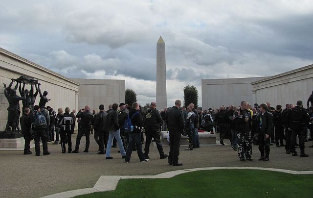 bikers looking around the large wall of remembrance