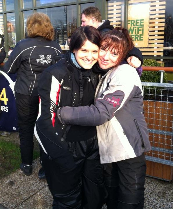 sharon and jeanette, 2 5 foot tall female bikers, having a hug
