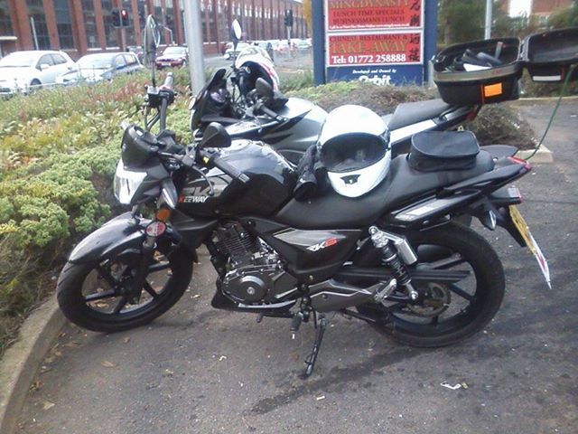 sharons keeway 125 with helmet and gloves outside preston harley