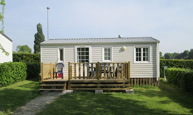 small static caravan with decking at the campsite in mamers