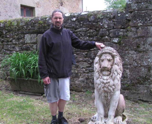 the bf stood next to a stone rampant lion pulling a growling face