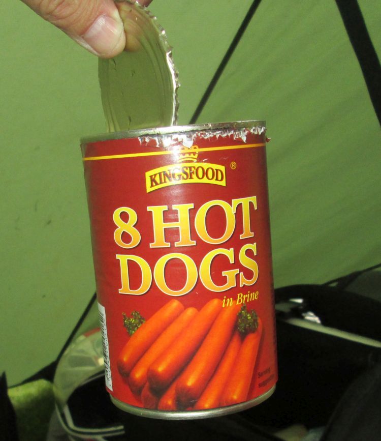 an opened can of hot dogs