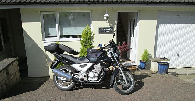 honda cbf 250 in the sun outside a small house in the isle of man