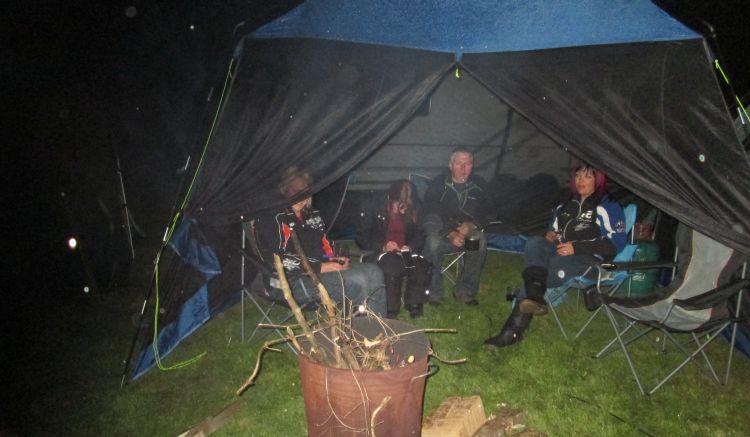 a gazebo with our friends inside at the campsite, in the dark