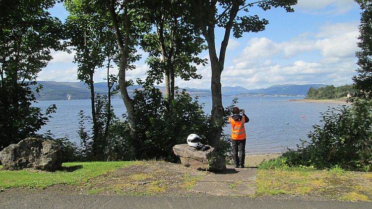 the gf in her bike gear takes a picture of the broad and mountainous bay at inverkip