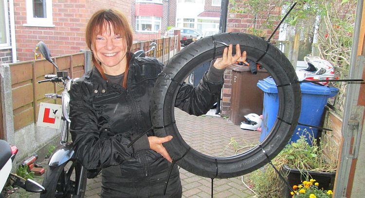 the gf stand smiling with the new tyre all zip tied up