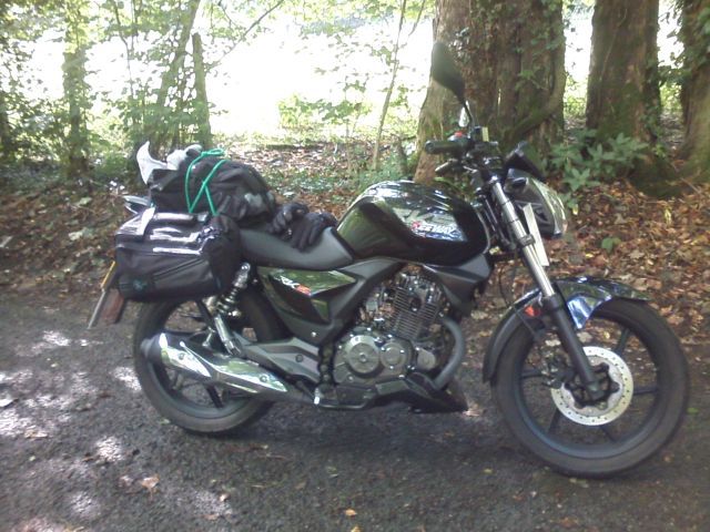 keeway rks125 in the wooded lane loaded up with saddlebags and a roll
