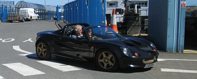 a lotus car coming off the ferry at douglas in the sun