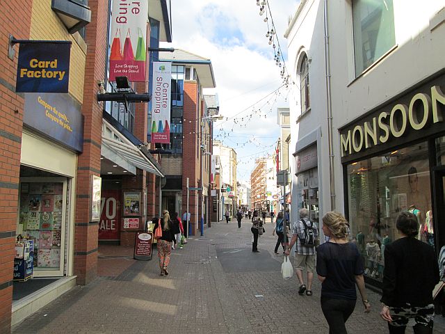 a long street filled with shops and their brand boards in douglas