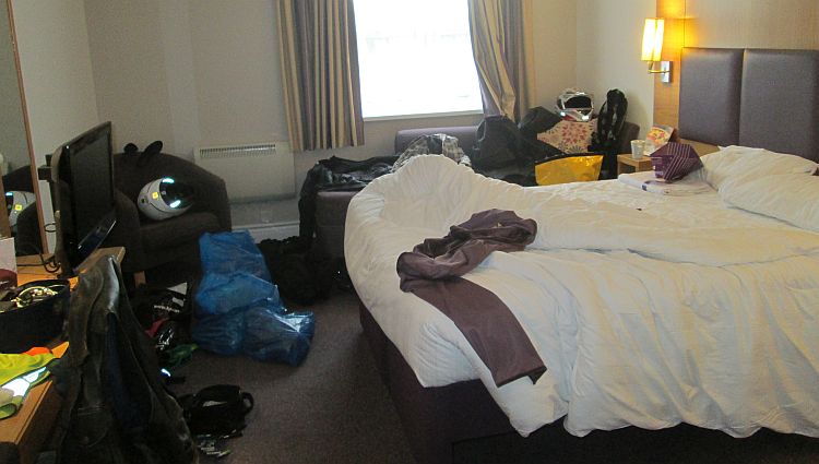 A hotel room filled with bike gear strewn about all over the place