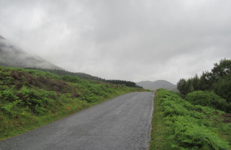 a misty empty lane lane leads across the remote Rannoch Moors