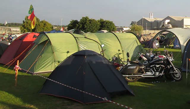 several tents of various sizes and style in the rally field