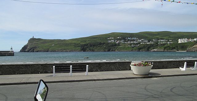 port erin harbour in the sun and with very little activity along the promenade