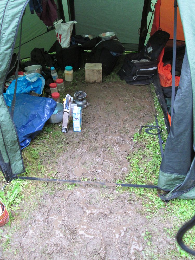 a muddy path runs into the tent porch and mud all around