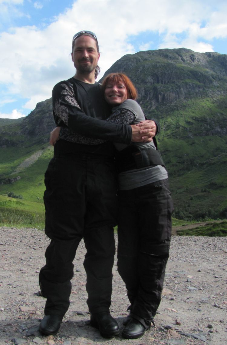 Ren and Sharon hug with clear skies and Glencoe mountains as a background