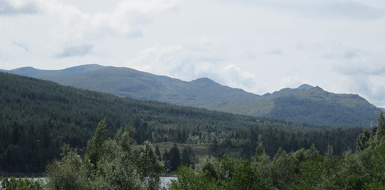 A typical Highland scene. Mountains, pine forests, light clouds and a loch