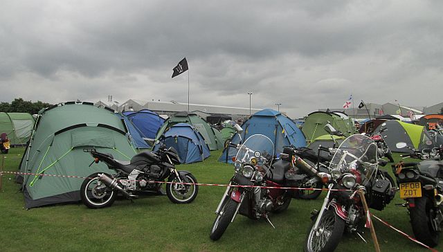 a collection of modern tents among the motorcycles at a rally