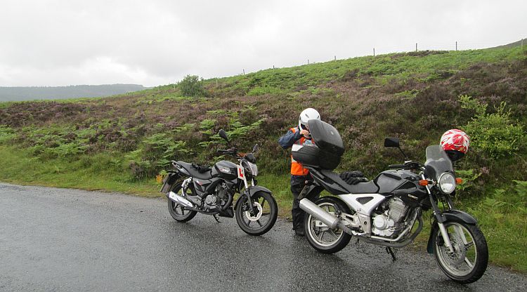 the gf rummages in my top box on a wet, misty highland road