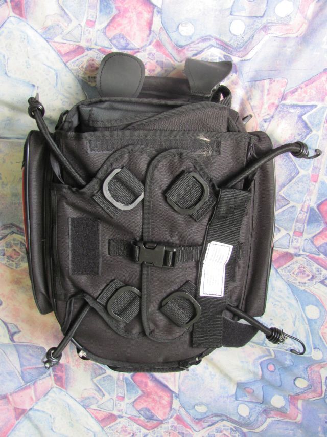 the underside of the pack showing both the magnetic flaps and the bungee cords