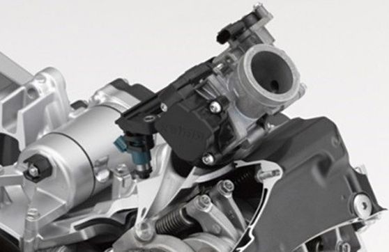 cutaway of honda's africa twin cylinder head and injection unit