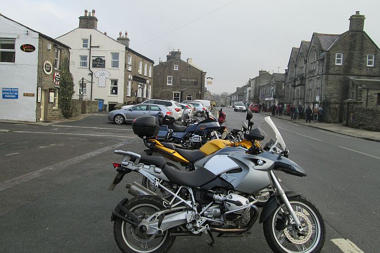 A line of motorcycles parked along the road at Hawes