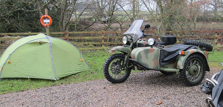 A Ural combination (side car and motorcycle) next to the tent at the Jernatter Rally