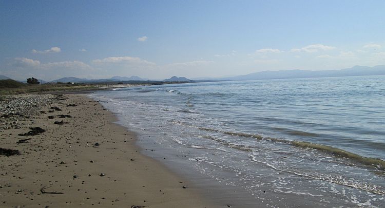 a long beach stretches off to the Welsh mountains in the far distance