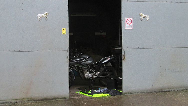 the cbf 125 in the doorway to the barn or shed where ren repairs the bike