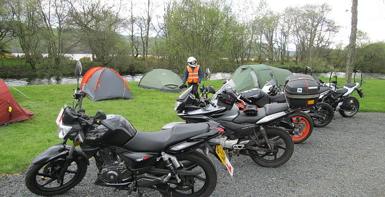 a row of motorcycles in front of tents at bala lake campsite
